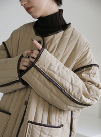 キルティングパイピングロングコート