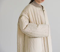 キルティングパイピングロングコート